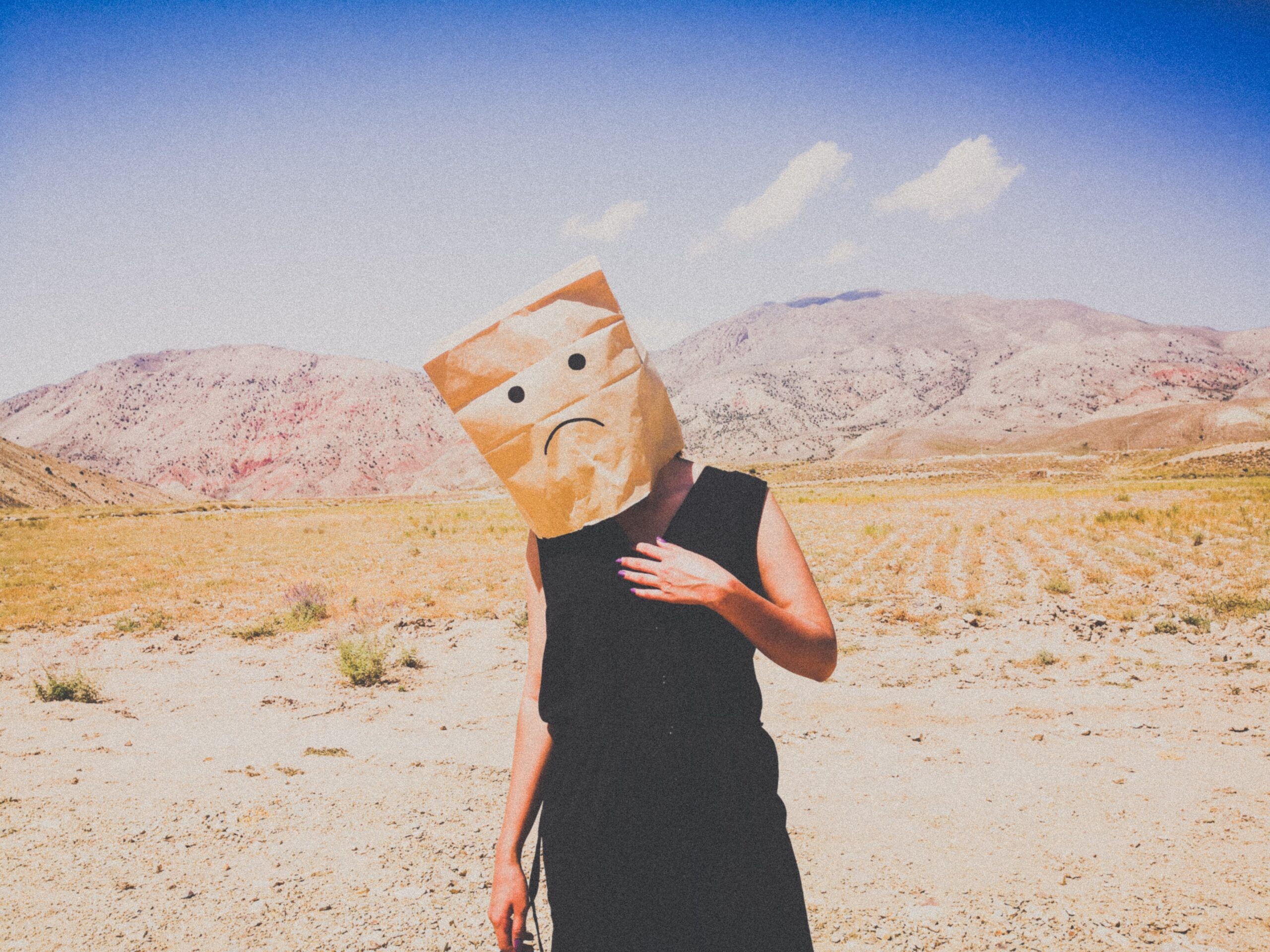 Picture of sad person wearing paper bag over head