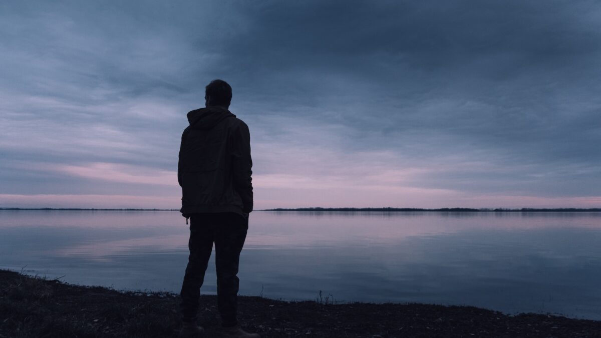 is being lonely bad for your health man overlooking lake